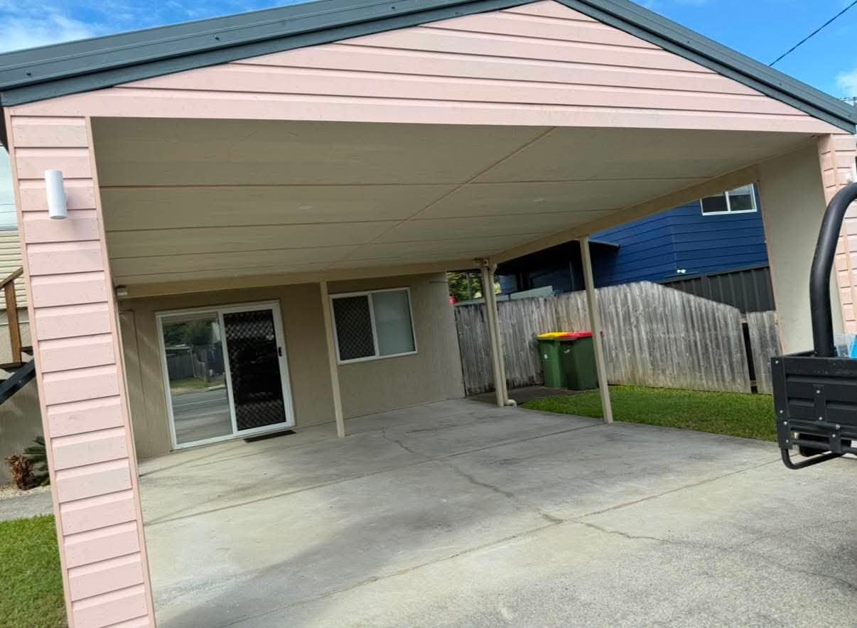 Completed covered area with clean soffit finish and concrete floor
