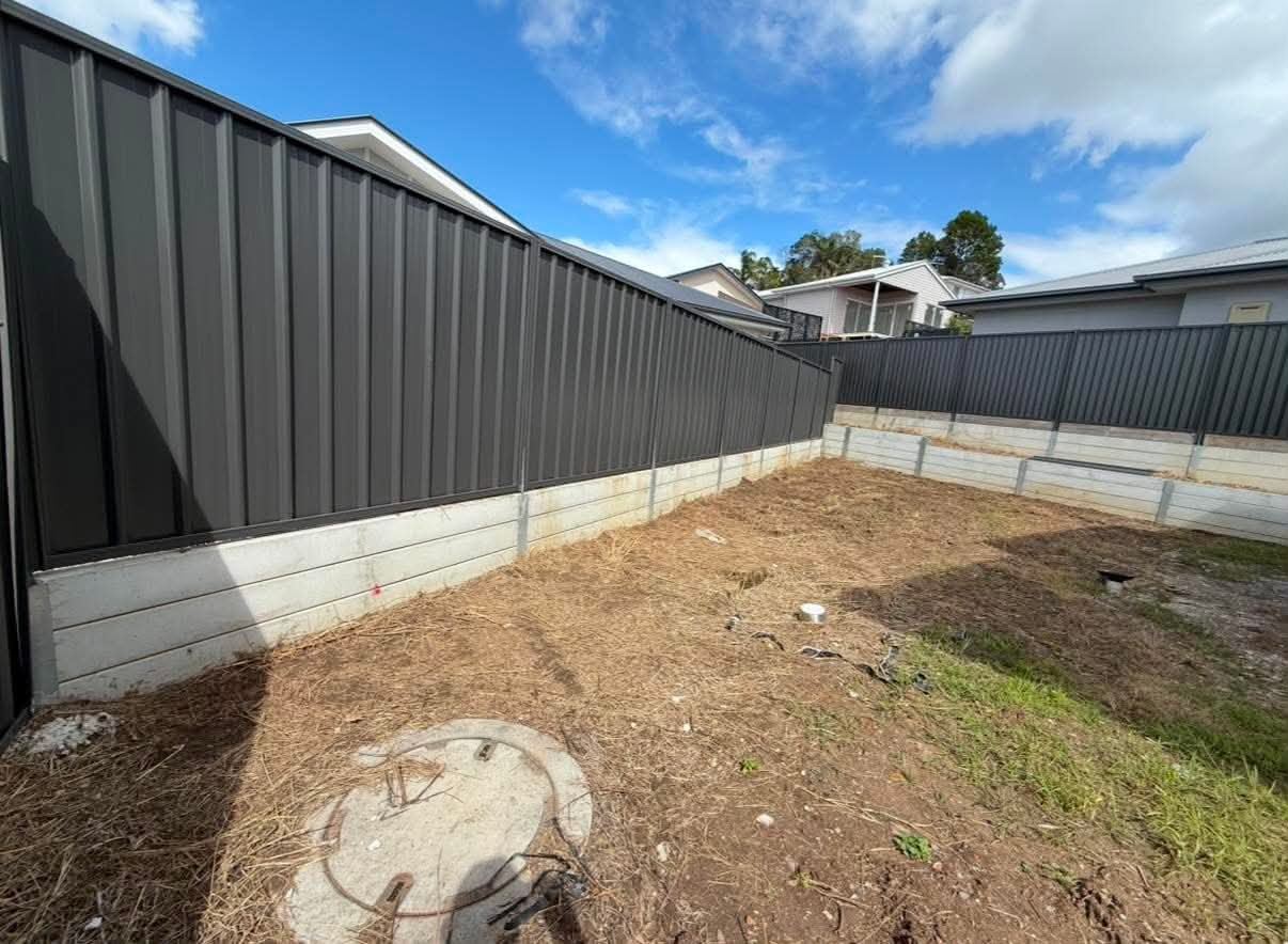 Prepared residential boundary with light fence panels before replacement