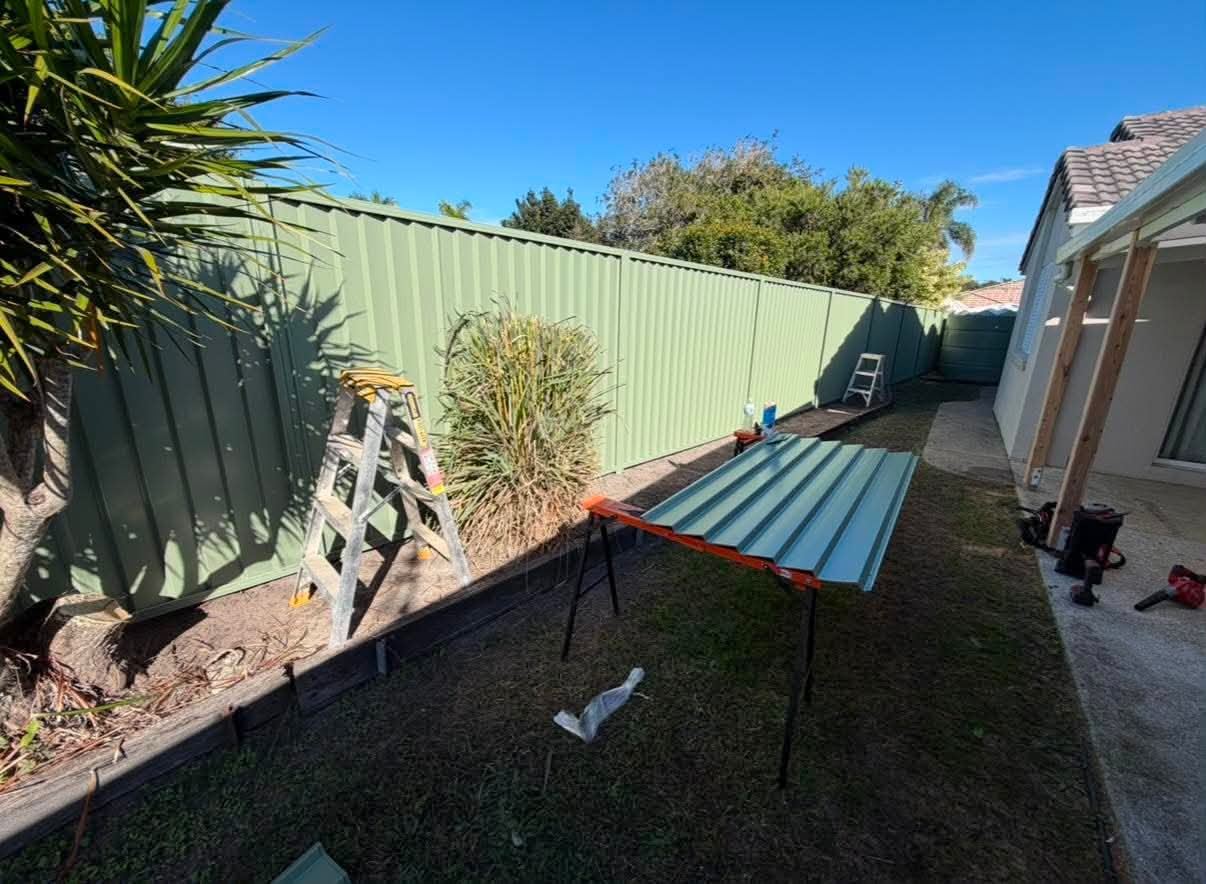 Materials positioned beside the house during fence installation