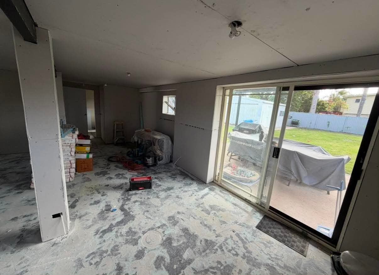 Interior conversion under construction with sliding-door access to the yard