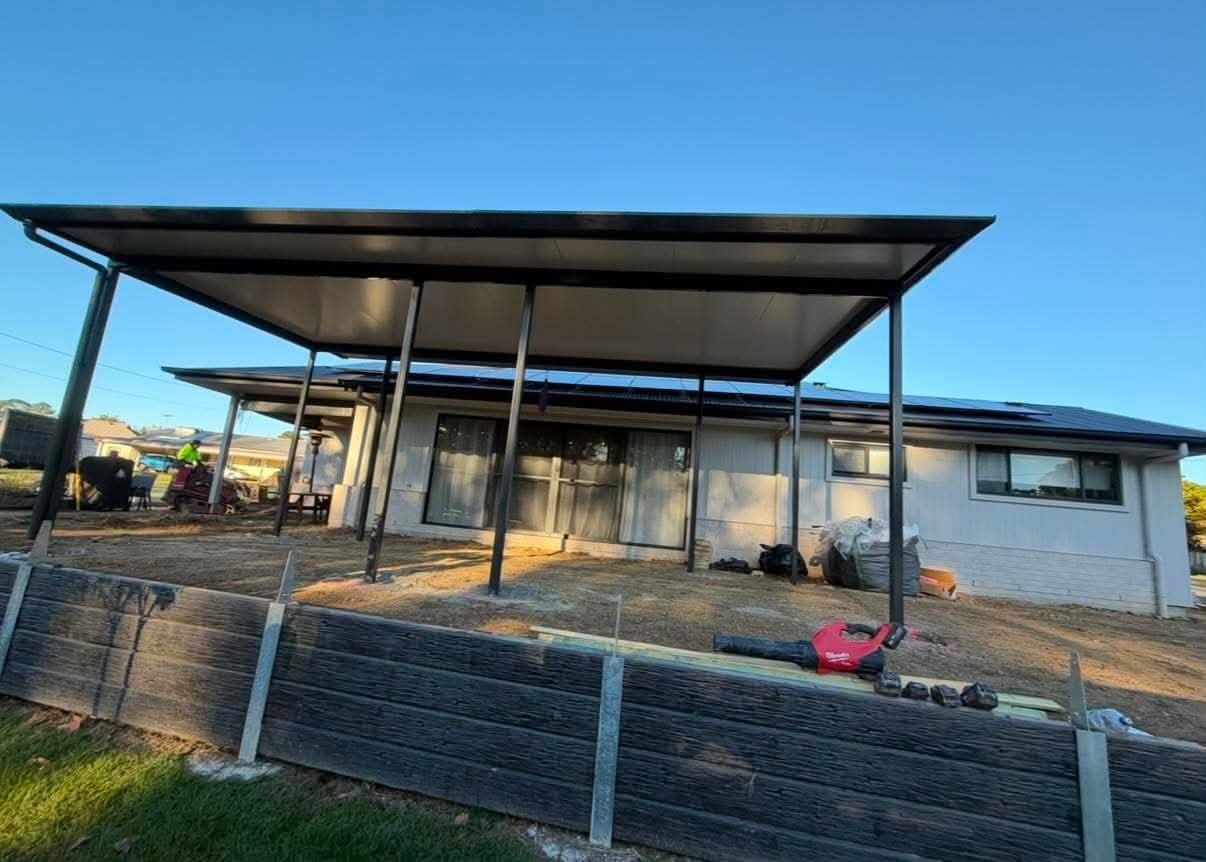 Insulated skillion patio with dark steel posts behind a single-storey home