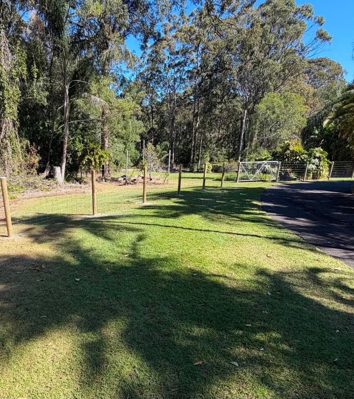 Established trees and lawn along the planned residential boundary