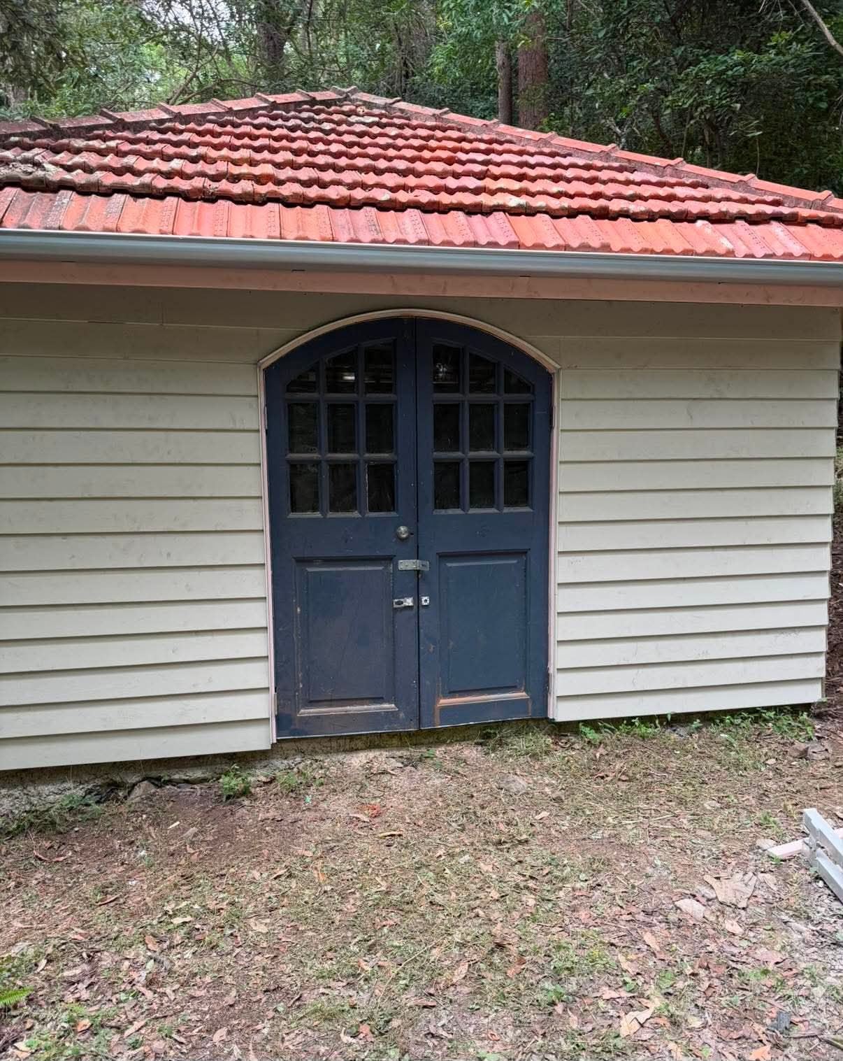 Garden shed front after cladding and exterior repair work